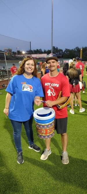 CTB General Sales Manager Jaymi Jander presents the charity bucket to the Enid Fire Department